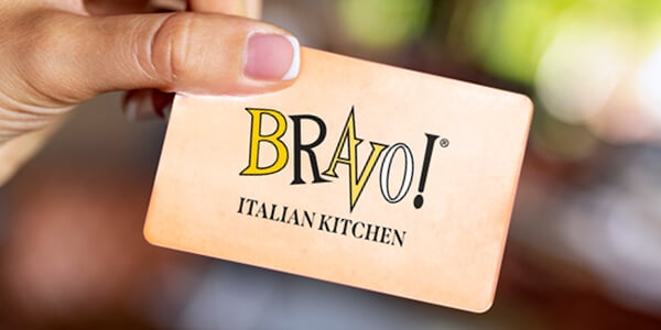 A hand holding a Bravo Italian Kitchen Gift Card